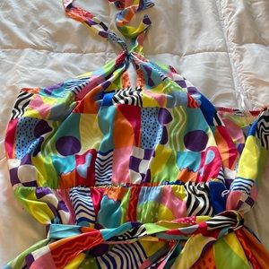 Eloquii bright halter top wide leg jumpsuit with open back.